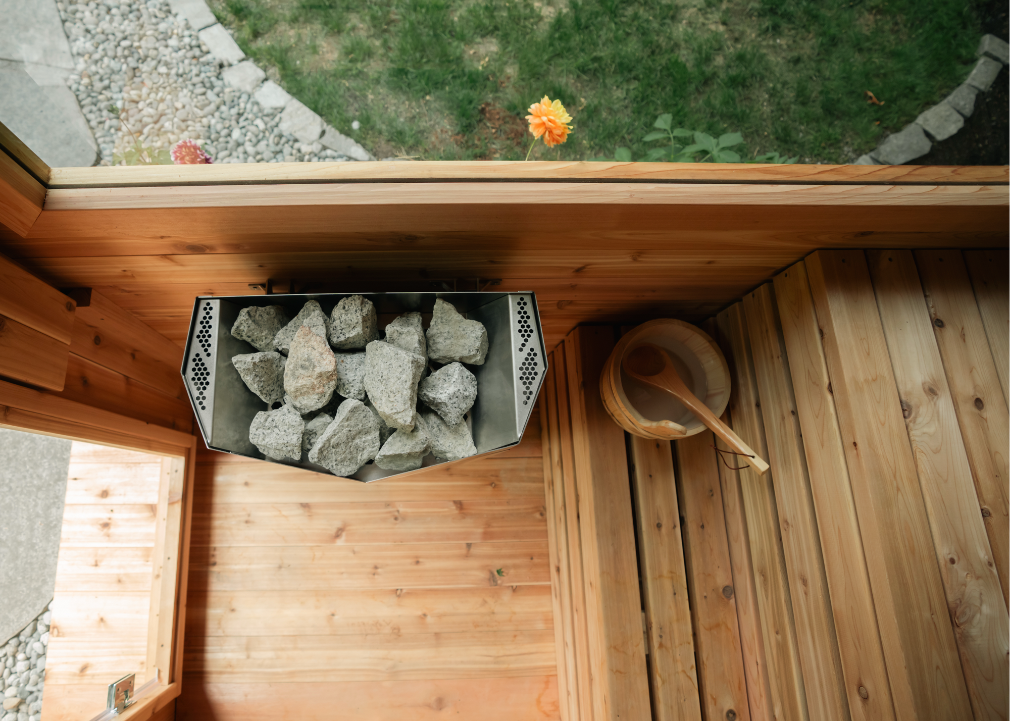electric sauna heater and bucket in cedar sauna