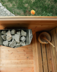 electric sauna heater and bucket in cedar sauna